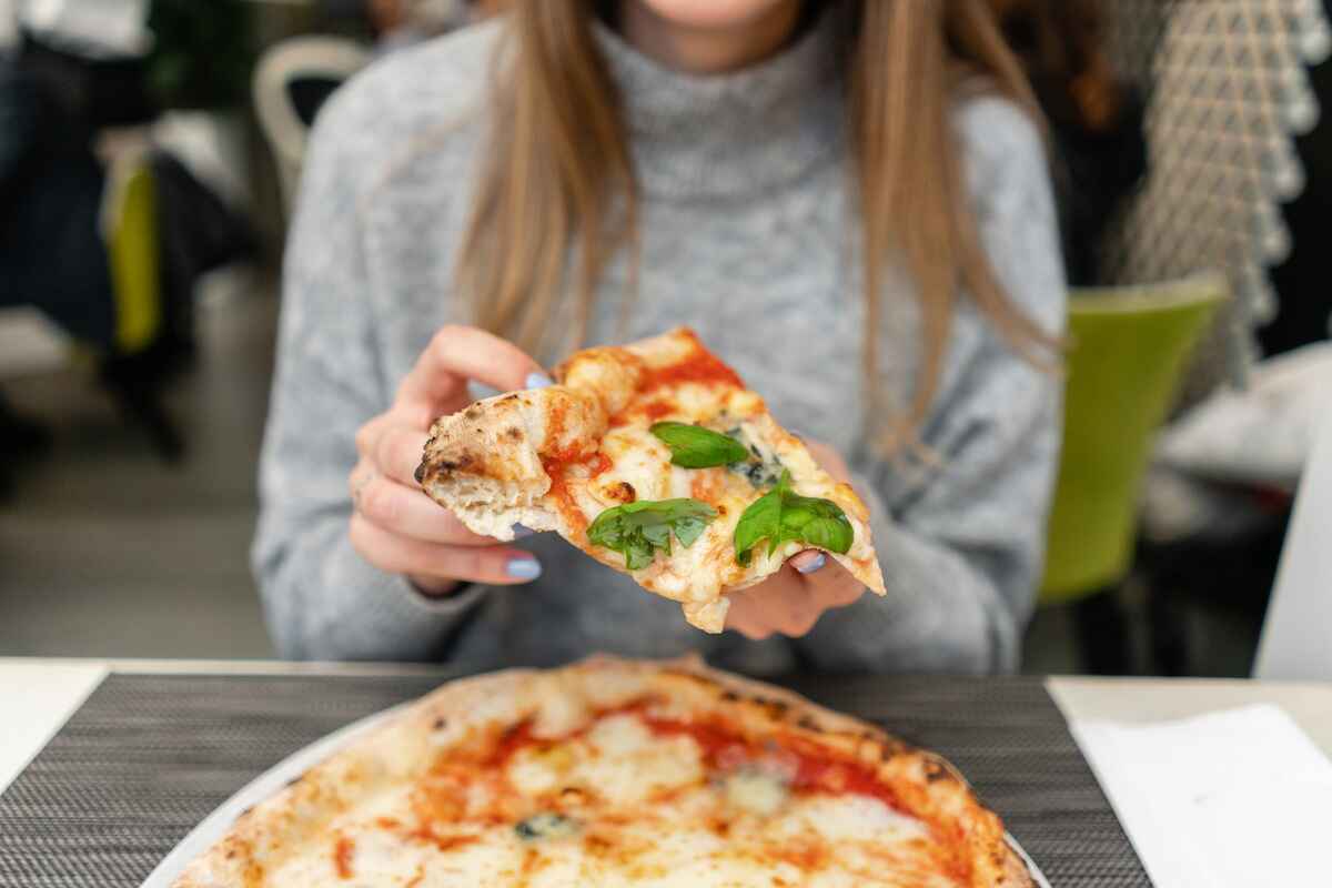 Woman with celiac disease eats gluten free pizza