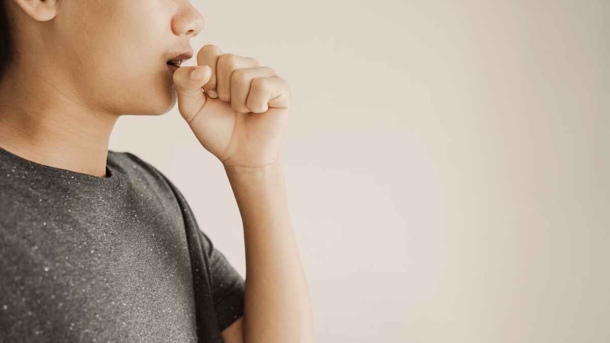 Boy with whooping cough covers cough