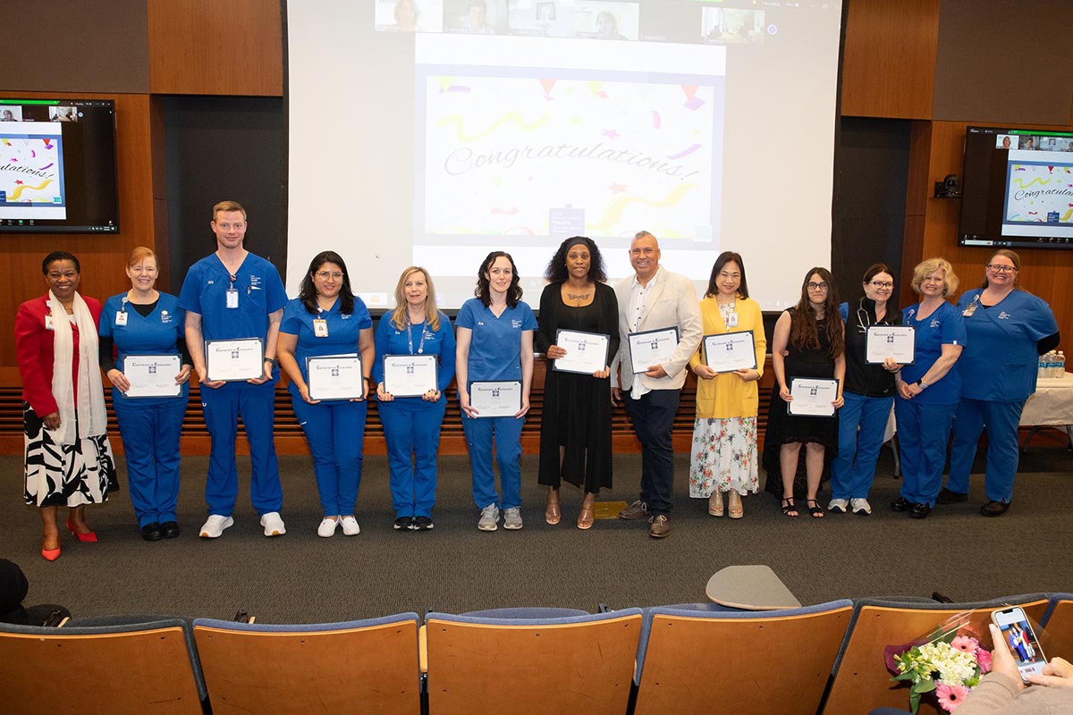 Ena Williams, RN, YNHH CNO; awardees Maria Wasko, RN, Shane Lange, RN, Katherine Alban, RN, Penny Denos, RN, Nichole Ciccone, RN, Vanessa Dixon, RN, Tom Fedora, RN, Carolyn Fronda, RN, Bianca Morales, RN, and Deirdre Lonergan, RN; and Awards and Recognition Committee members Darcy Dugas, RN, and Haideen Suto, RN. Missing from photo: awardee Jona Sager, RN